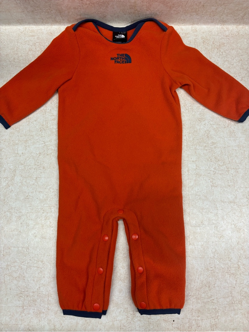 The North Face Orange Fleece Baby One-Piece with Navy Trim